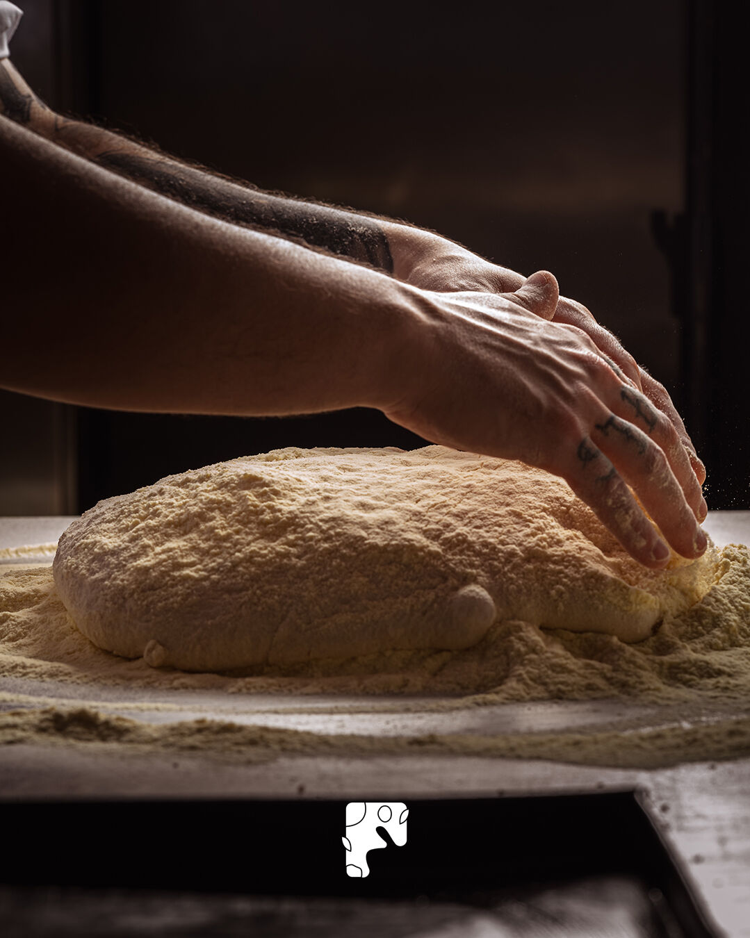 Le mani del pizzaiolo lavorano l'impasto